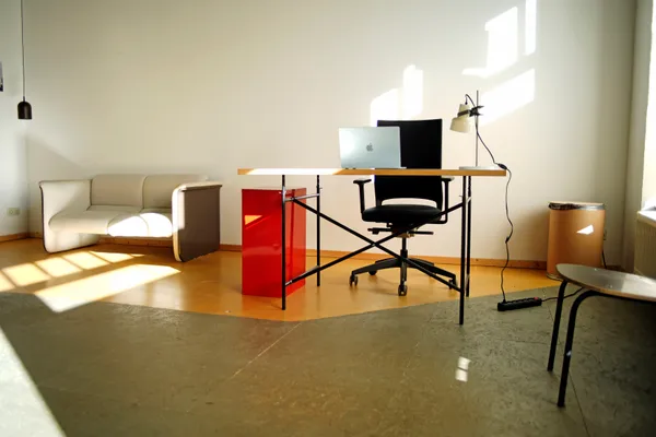 Private workspace with laptop and lounge sofa at KOTEKA coworking space Leipzig