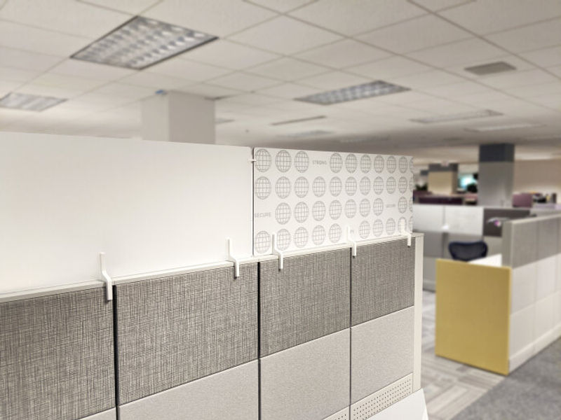 Adjoin Adaptive Panel System for workstations. Frosted Acrylic Panel & Moxie Graphic Panel (ACM) showing custom client branding.  Both with white adapters.