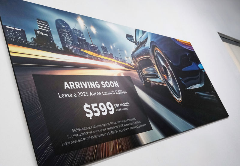 Looking up at a large-scale series of magnetic wall graphic in a car dealership promoting a lease deal.