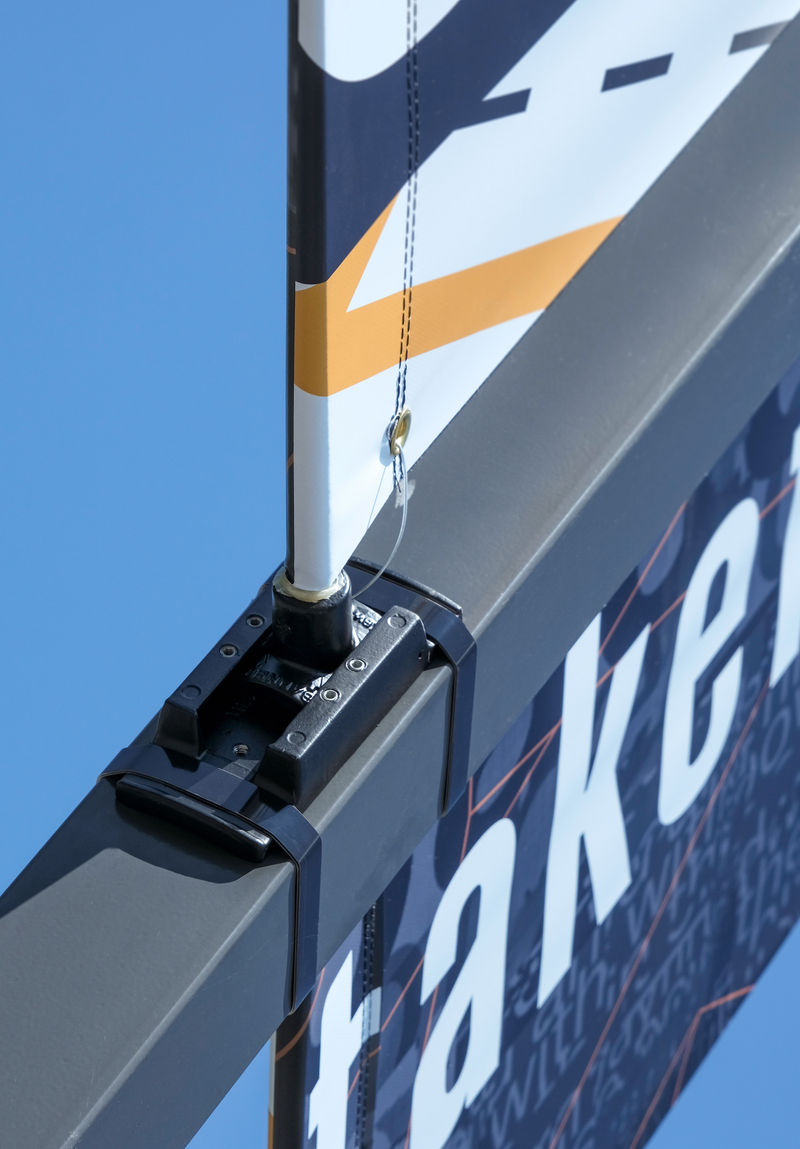A detail photo a two-sided exterior pole banner and the banding hardware wrapping around a square pole.