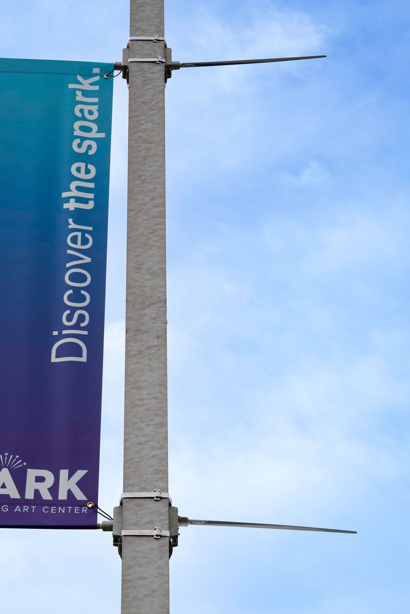 An exterior pole banner and hardware revealing the canted poles that provide tension on the banner.