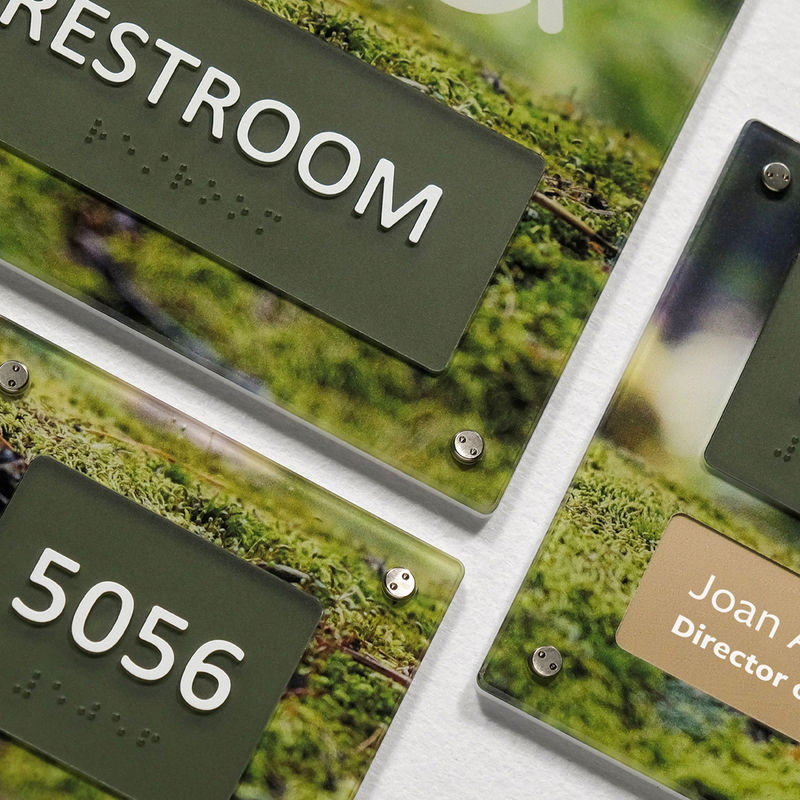 Multiple Empath interior wayfinding signs with back printing of calming green moss.