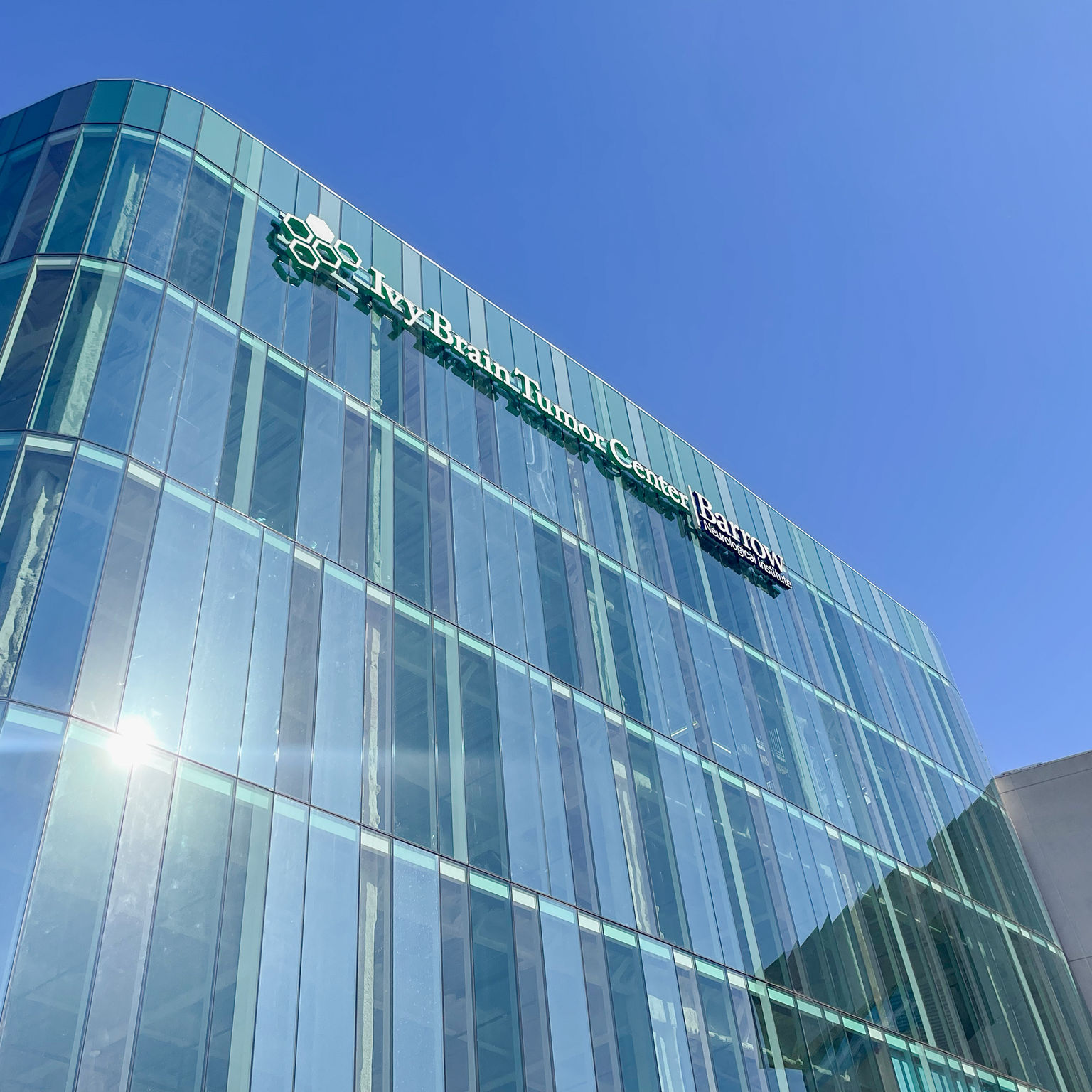 On-building dimensional logo and letter installation on the top floor "Ivy Brain Tumor Center" tower.