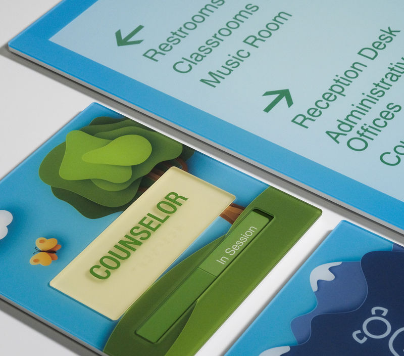 A grouping of colorful custom second-surface printed interior signs for schools.