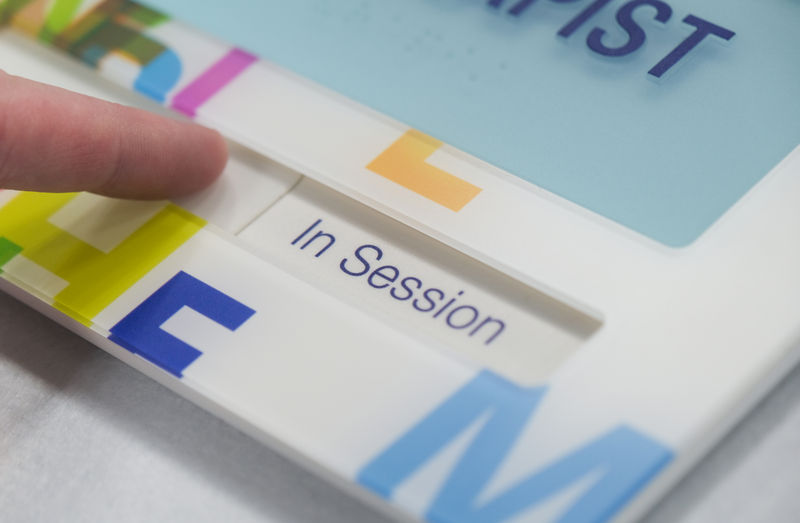 Inspire Room ID sign with tamper-resistant status slider, custom graphics, and one-piece raised lettering and braille