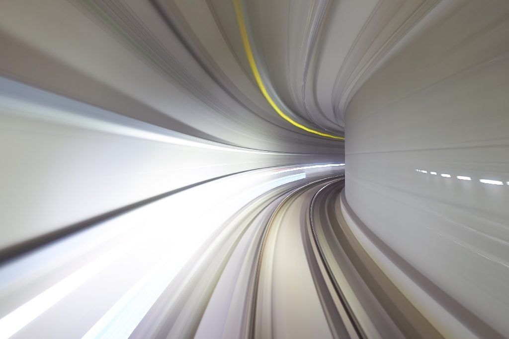 A tunnel in time lapse curving around a corner