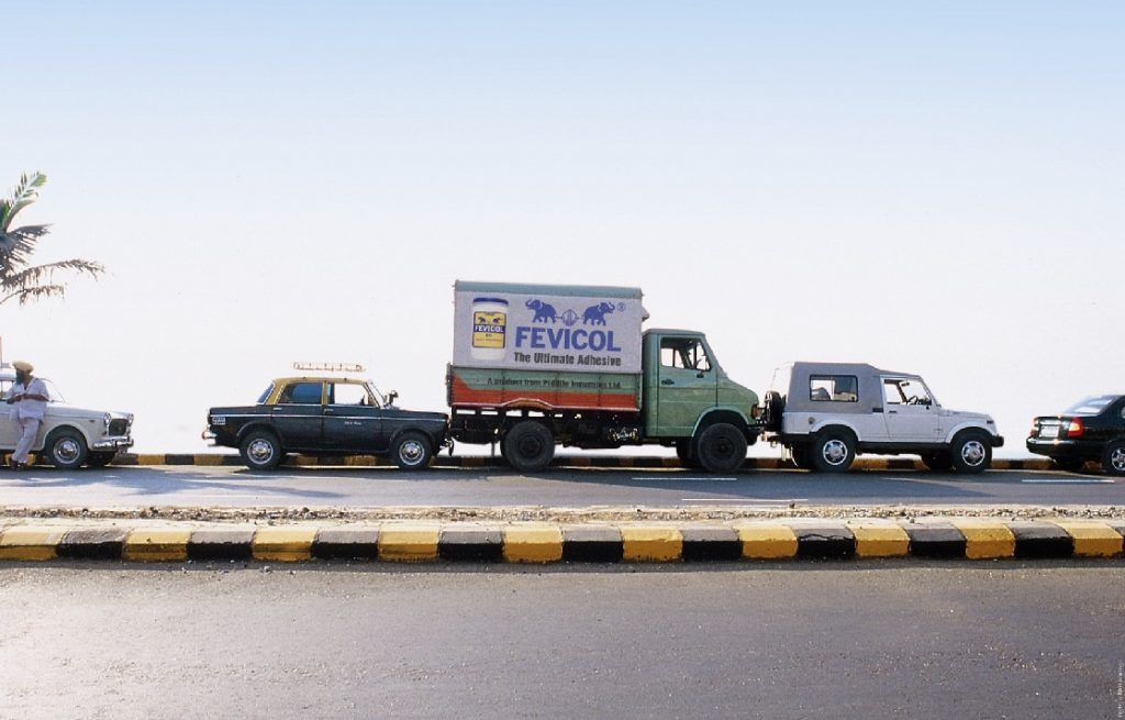 A poster for Fevicol showing a truck wedged between a taxi and a jeep
