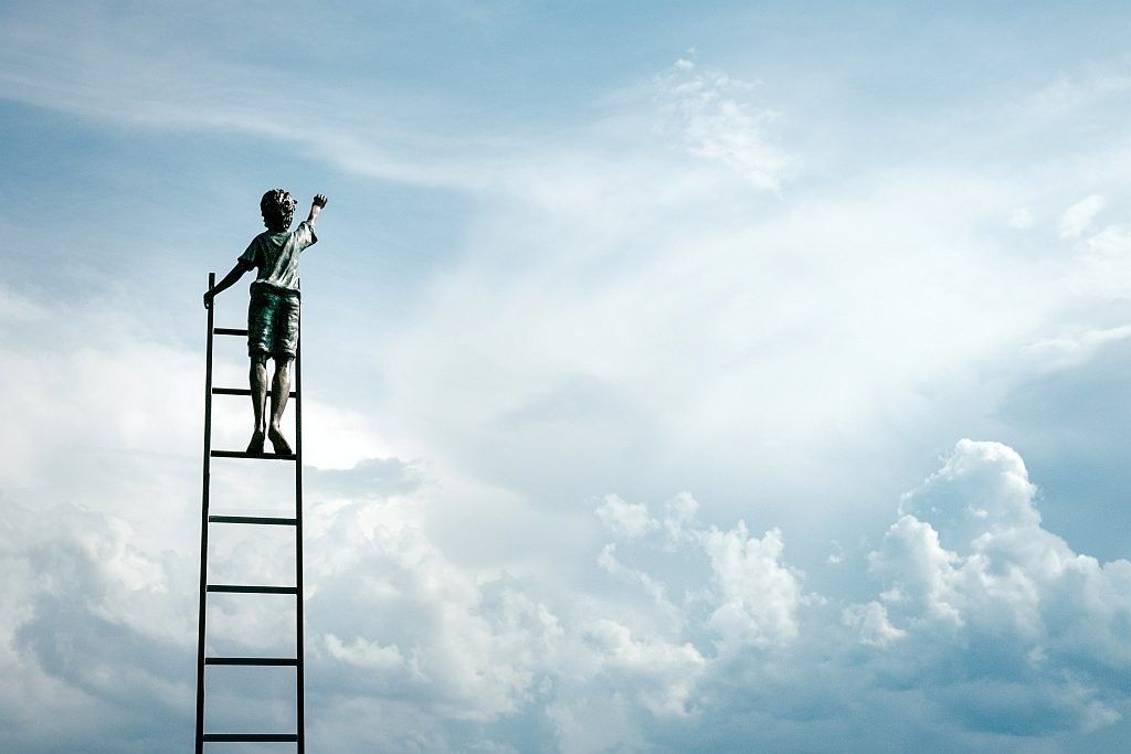 A boy up on a ladder reaching for the sky
Photo by Samuel Zeller on Unsplash