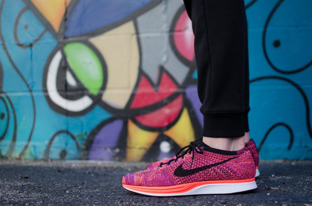 Nike shoes against a graffiti wall Photo by Hunter Johnson on Unsplash