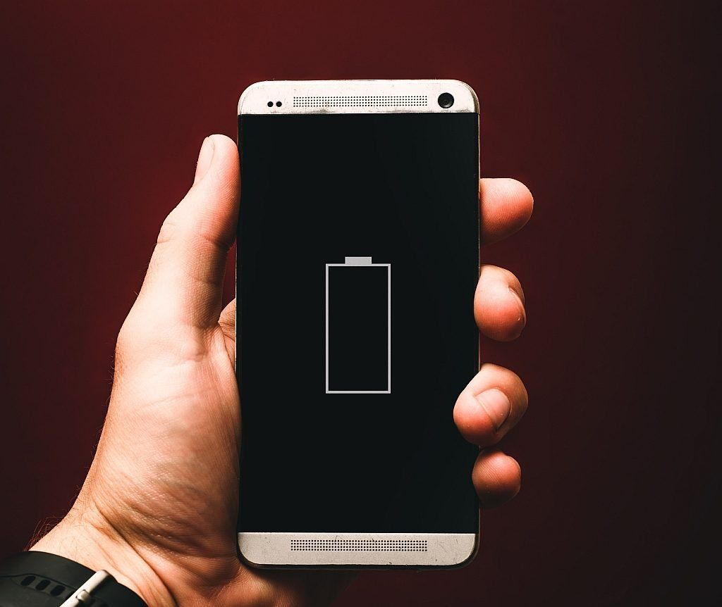 An iPhone with the battery at almost zero level