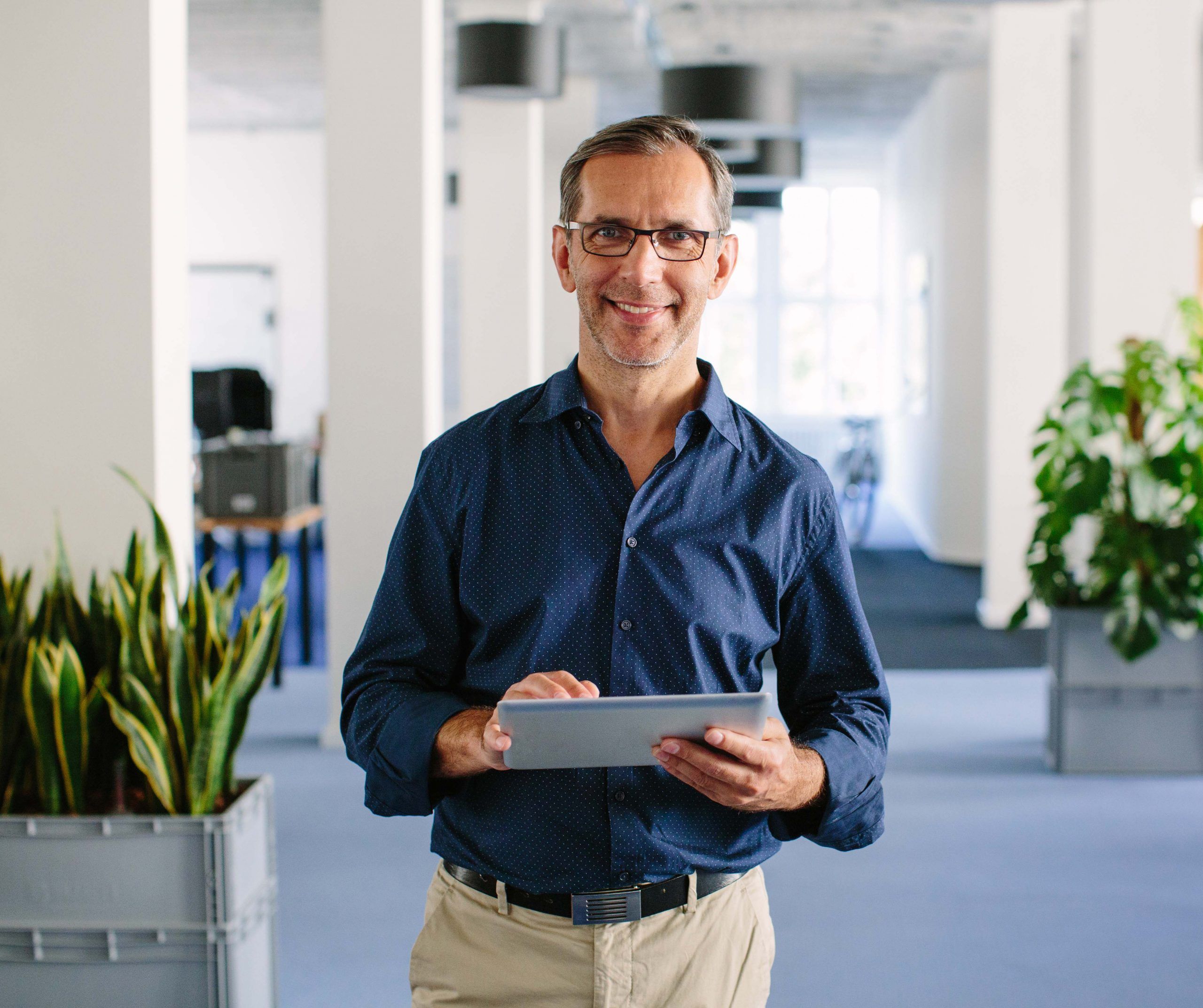 senior business man using the WorkBuddy app on ipad