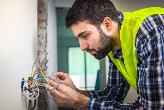 electricians working on light switch electricians working on light switch