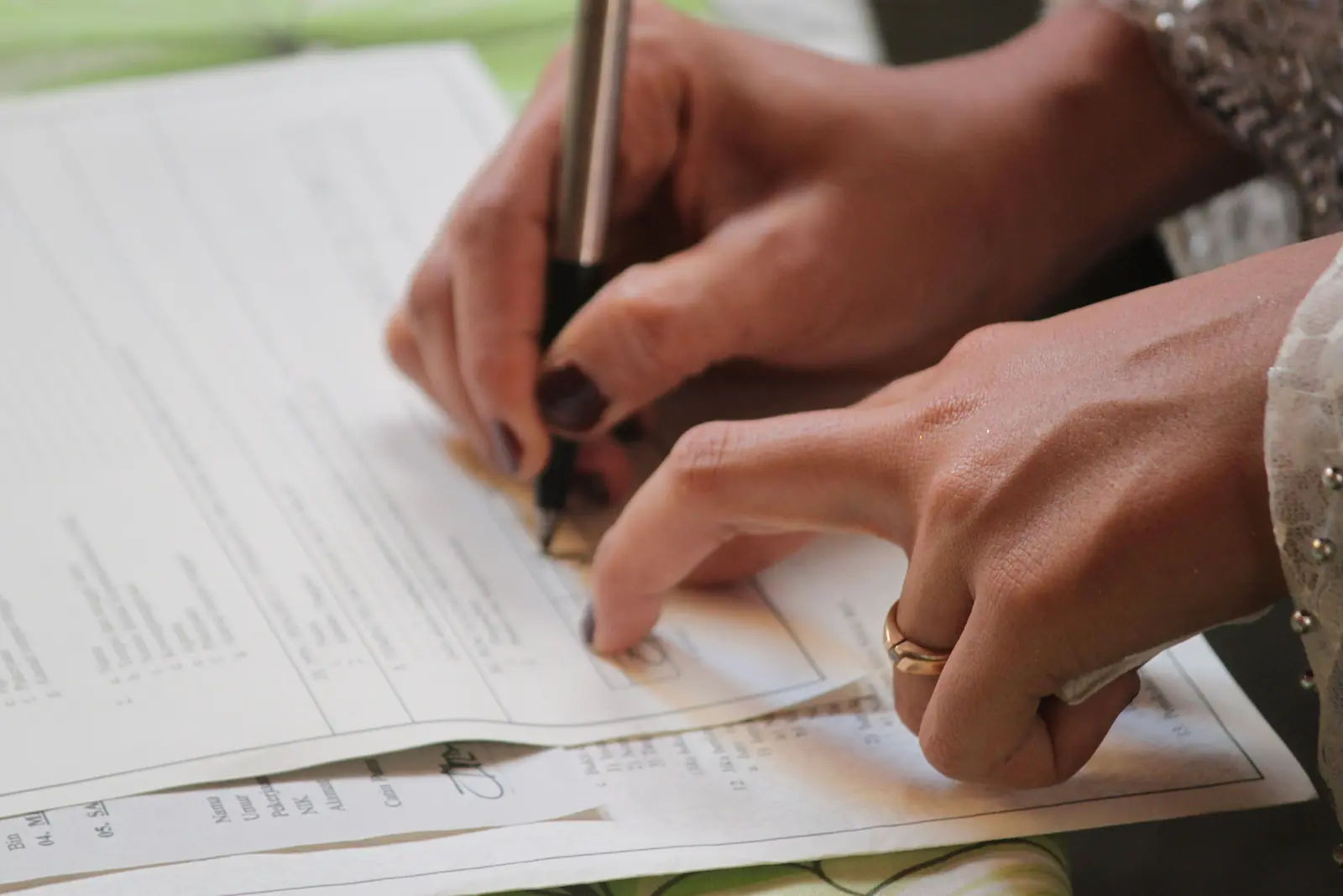 Person signing divorce paperwork on a legal form