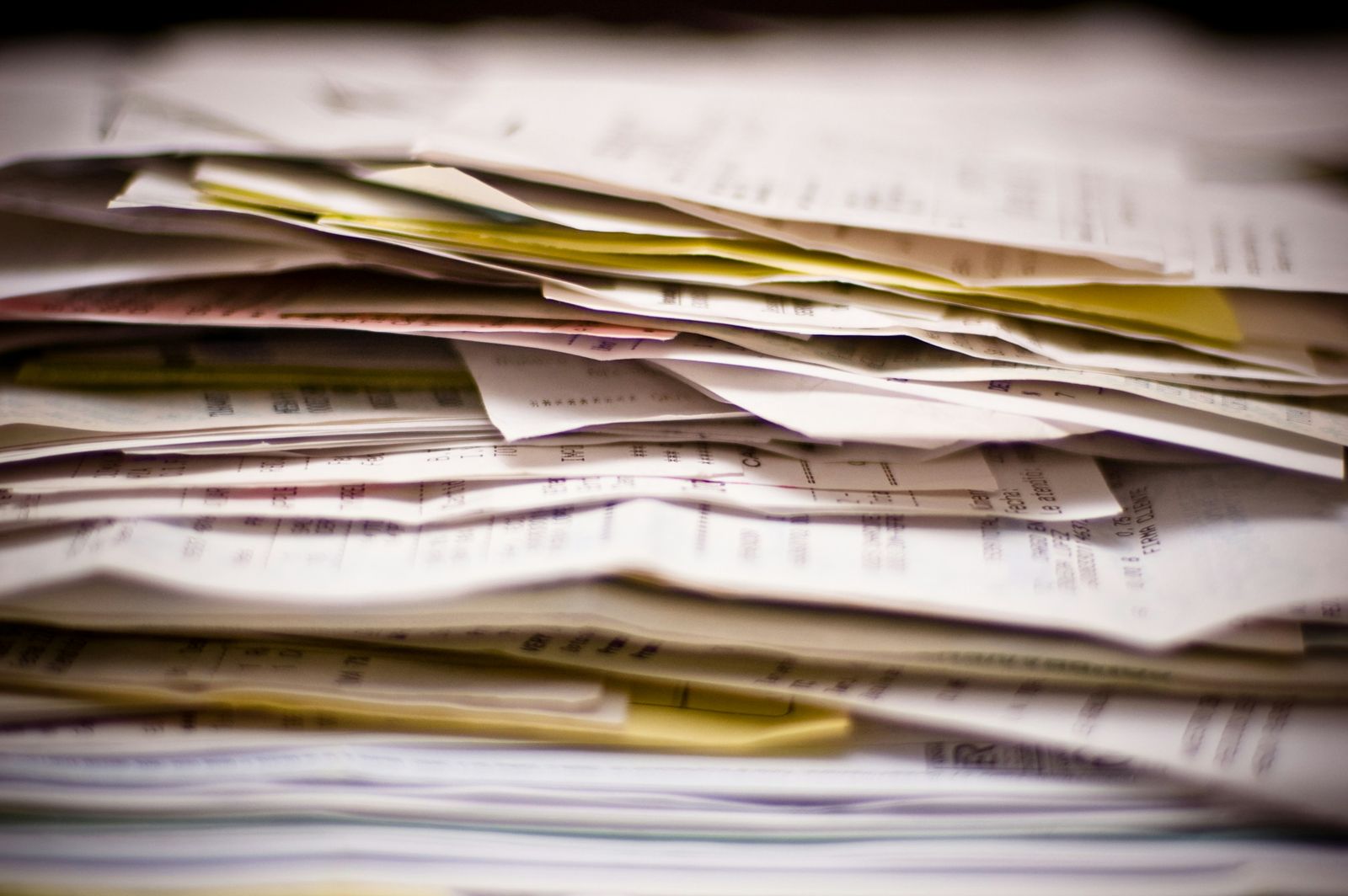 Business compliance paperwork and legal documents arranged on an office desk.