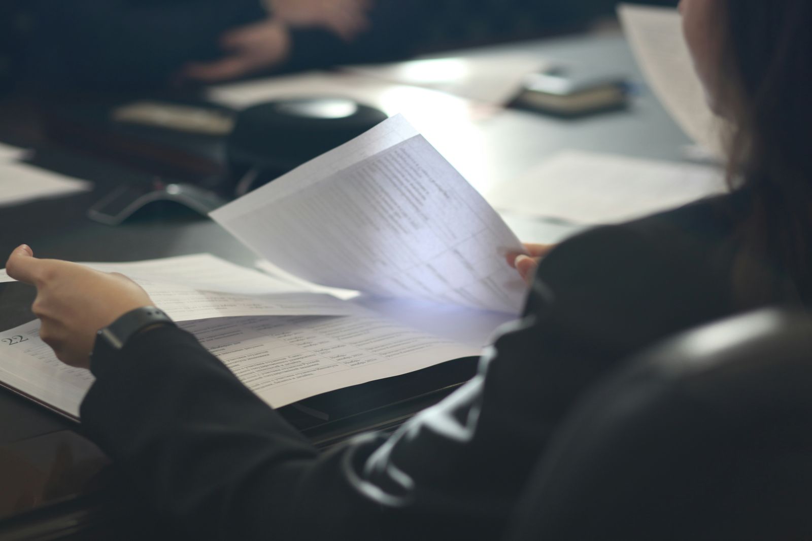 Person reviewing legal documents at a desk