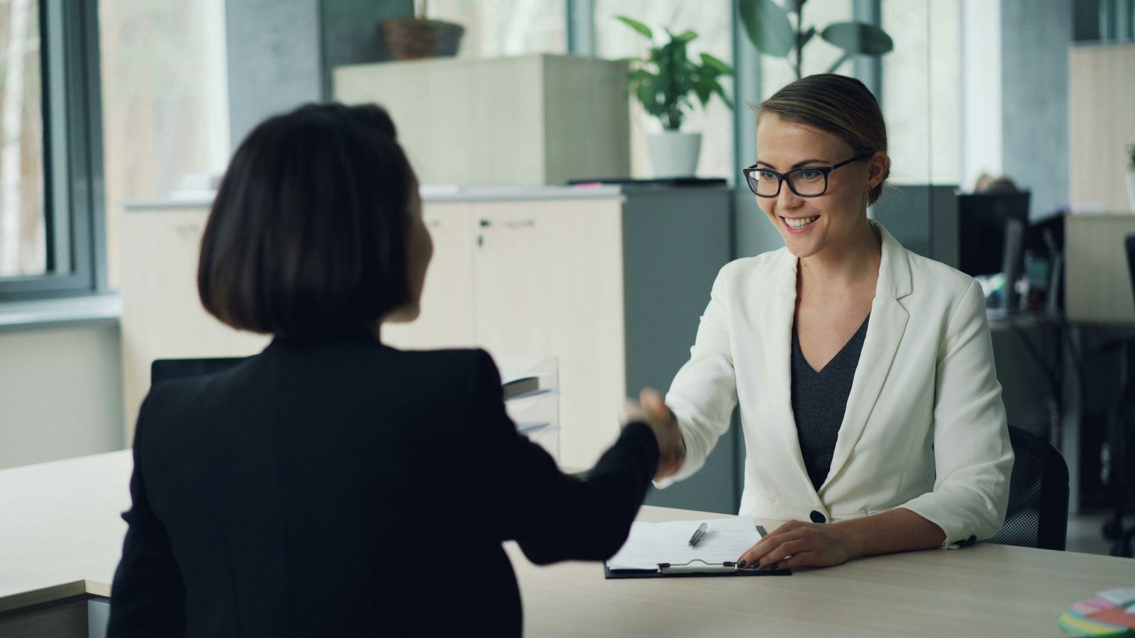 Candidate and hiring manager shaking hands after an internship interview.