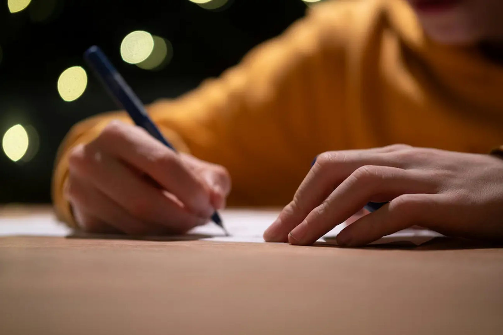 Close-up of hands signing a document, symbolizing completing a lease agreement template.