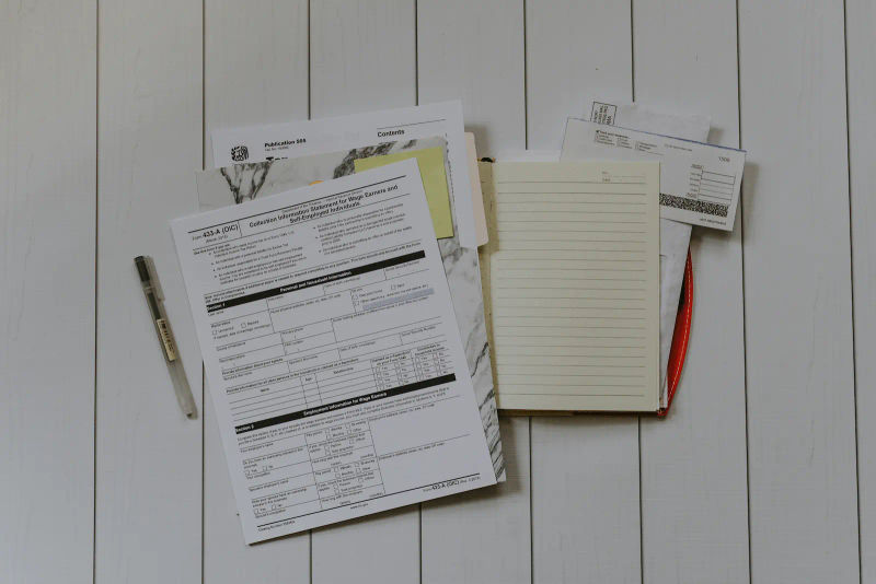 Divorce court forms and a blank notebook on a desk