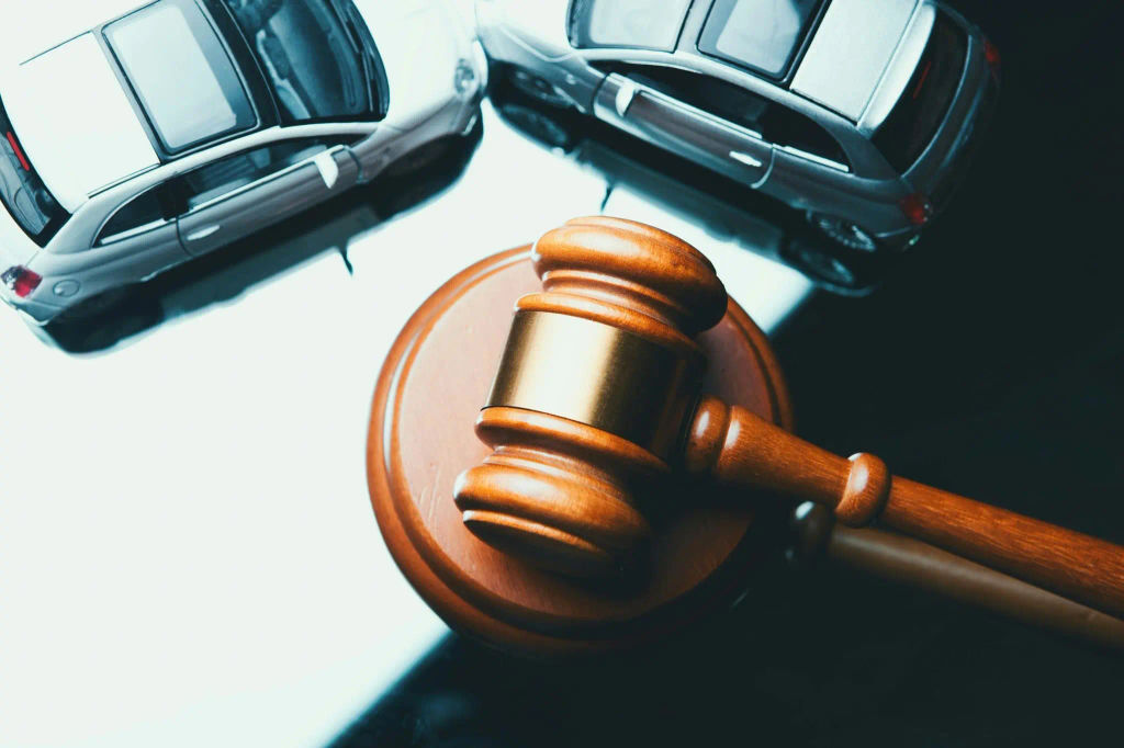 Court gavel beside two vehicles, symbolizing parking contract legal requirements.