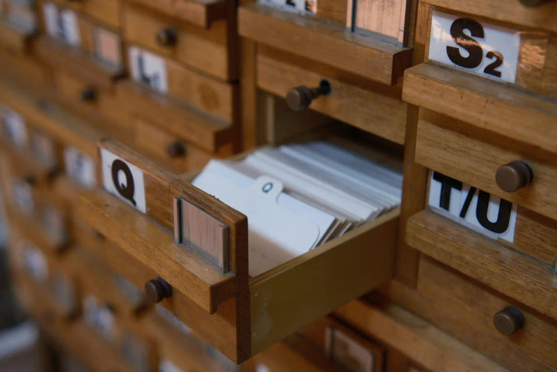 Wooden file drawers with an index card drawer pulled out, searching for the right template