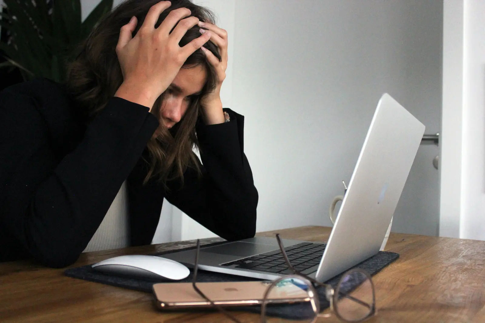 Worried adult at a table with a laptop, trying to get the consent document right