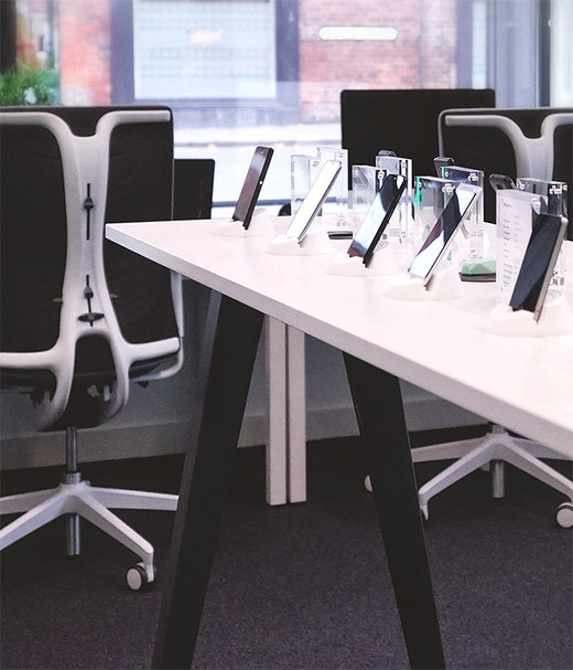A collection of mobile devices on a white table inside the Binaryfold4 office