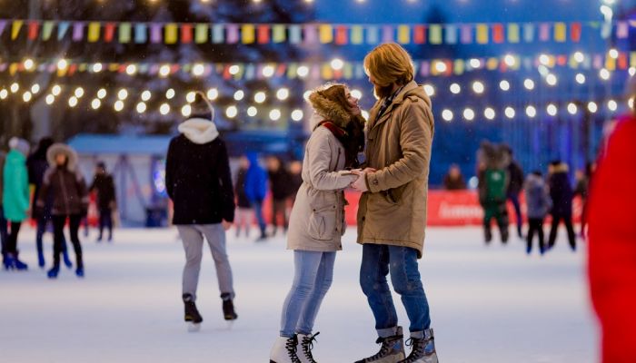 Couple on ice rink being romantic