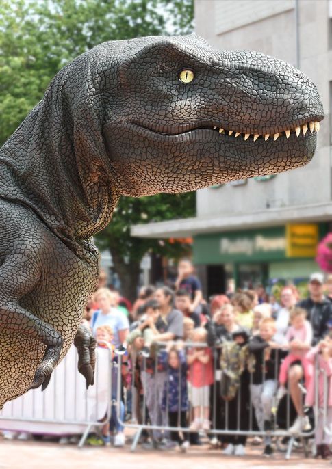 Zeus T Rex encounter in front of a crowd of people.