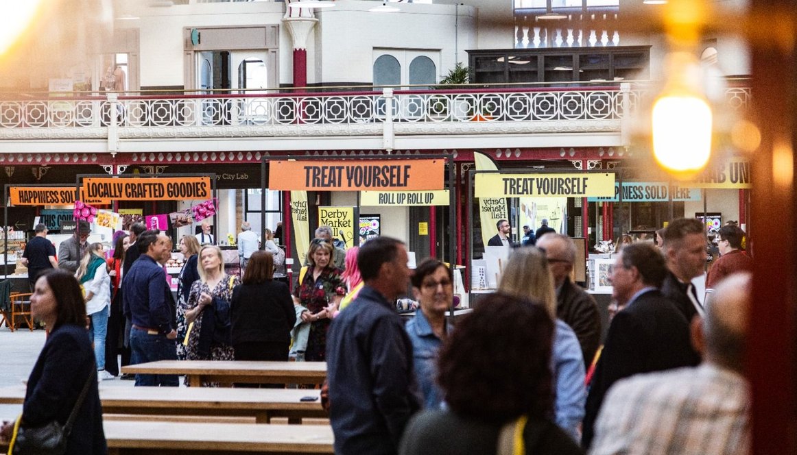 Crowd of people and pop up traders at Derby Market Hall