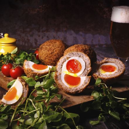 Gourmegg-scotch-eggs-on-serving-platter-with-salad-and-beer.jpg