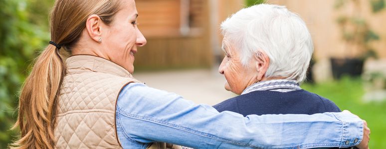 Woman with arm around elderly woman