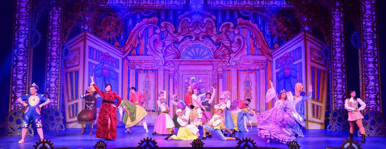The cast of Cinderella pose on stage.