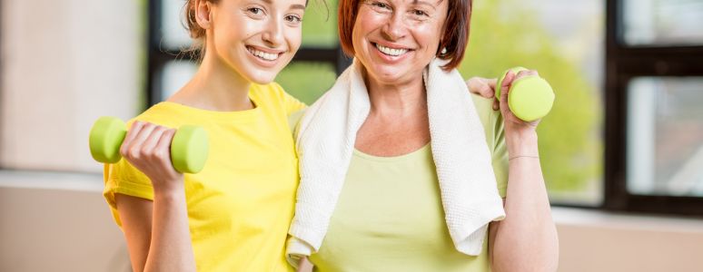 Two women smiling and exercising together