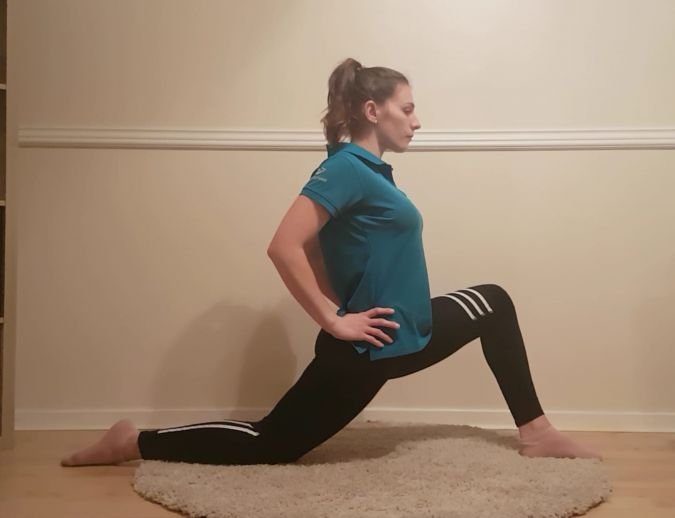 women kneeling one the floor lunging forward stretch
