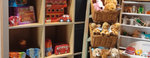 image shows shelving with soft toys and books on