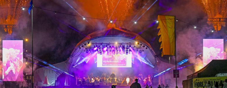 Distance shot of Darley Park stage at night with audience and light effects