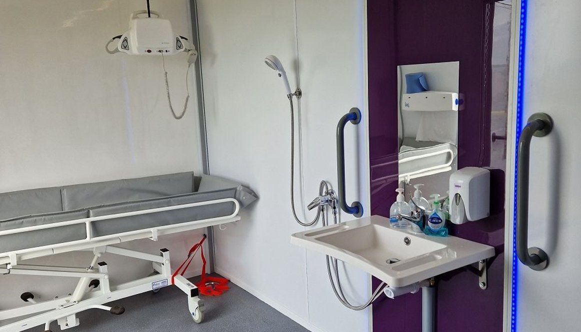 Interior of Mobiloo showing sink, hoist and wash facilities.