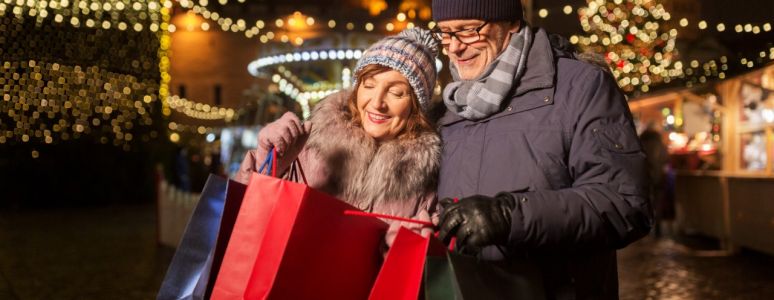 Couple out shopping at night surrounded by illuminations