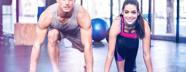 Man and woman in gym doing exercise