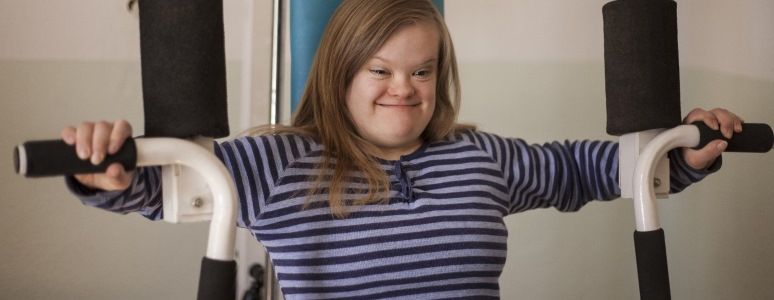 Young woman using gym equipment