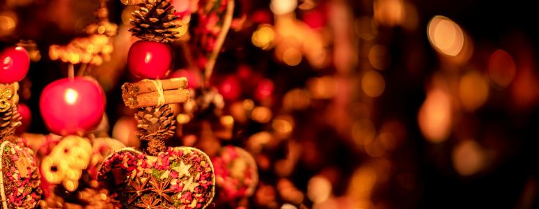 Red and gold Christmas decorations against a blurred background