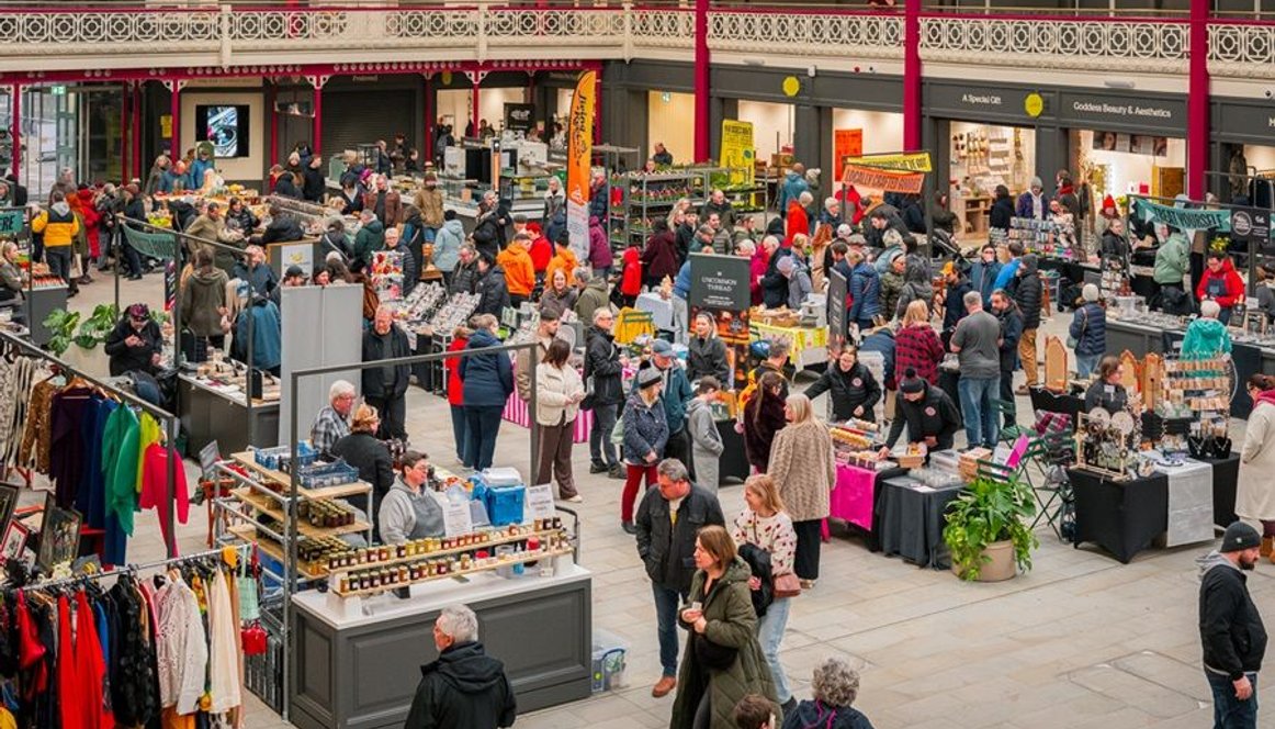 Crowd of people and pop up traders at Derby Market Hall