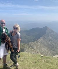 a image of Marie Cheetham up a mountain smiling