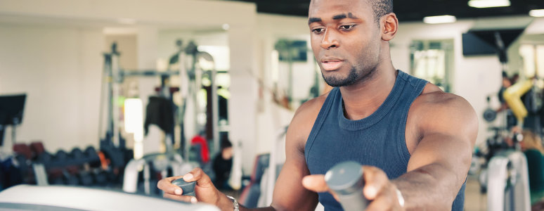 man running on cross trainer