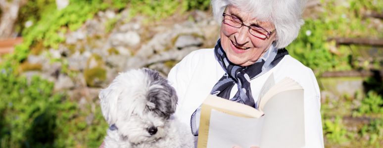 Woman with dog reading book