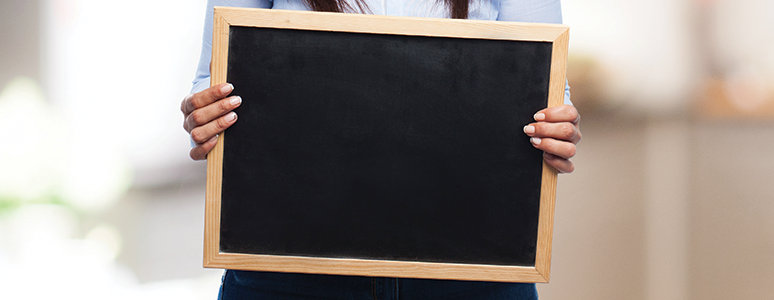 picture of hands holding a blackboard