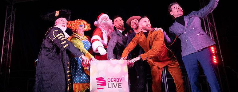 Pushing the plunger (left to right) Mayor of Derby Cllr Robin Wood, Dame Morgan Brind, Father Christmas and The Overtones