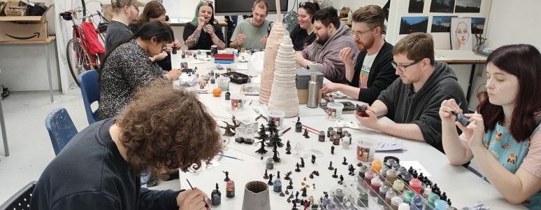 The Derby Dungeons and Dragons Group sitting together at a table
