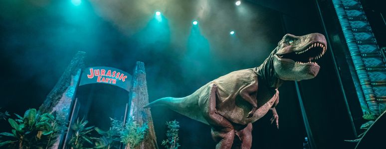 A model of a TReX dinosaur stands on stage