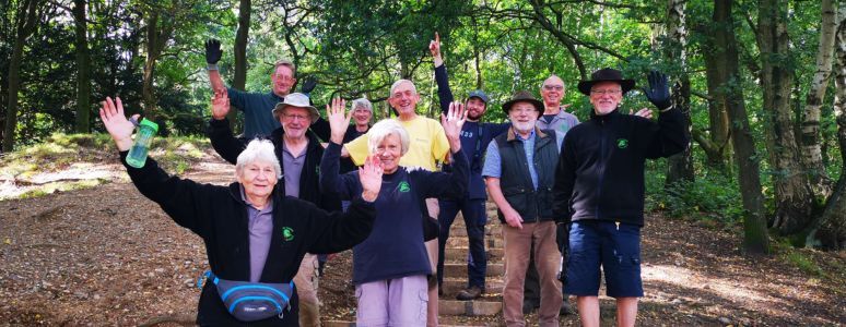 A group of Parks Volunteers smile at the camera.